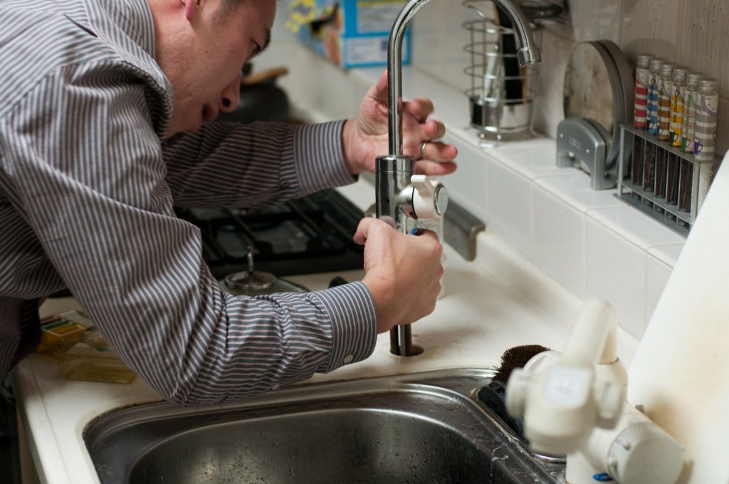 A plumber fixing a sink